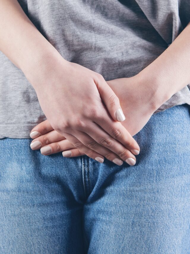 man in gray shirt and blue denim jeans