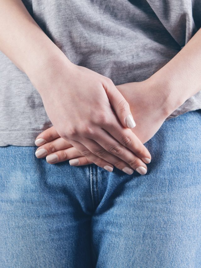 man in gray shirt and blue denim jeans