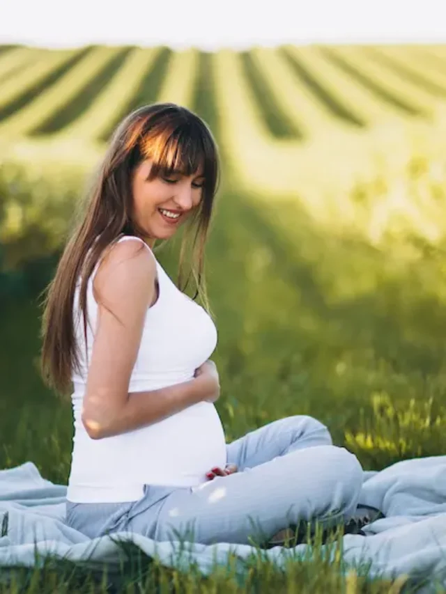 pregnant-woman-practising-yoga-field
